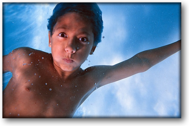 Photograph of young boy underwater