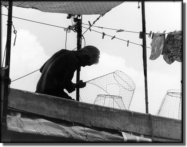 Fisherman on top of junk, Aberdeen, Hong Kong